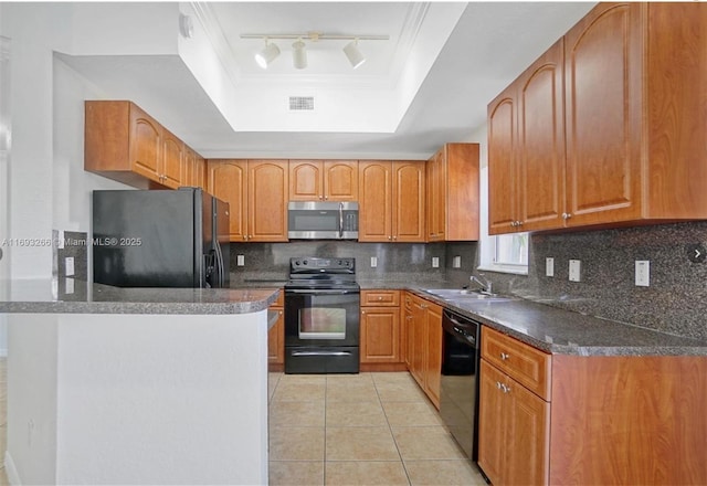 kitchen featuring tasteful backsplash, black appliances, sink, light tile patterned flooring, and a tray ceiling