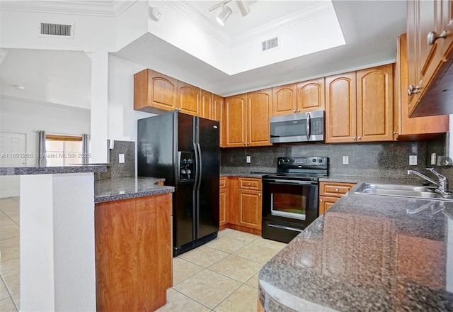 kitchen featuring tasteful backsplash, black appliances, kitchen peninsula, sink, and light tile patterned floors