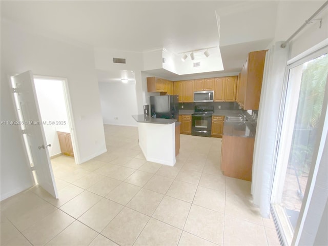 kitchen featuring black appliances, light tile patterned floors, and sink