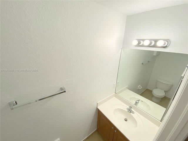 bathroom with toilet and vanity