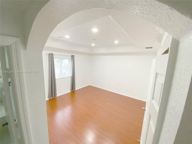 spare room with hardwood / wood-style floors