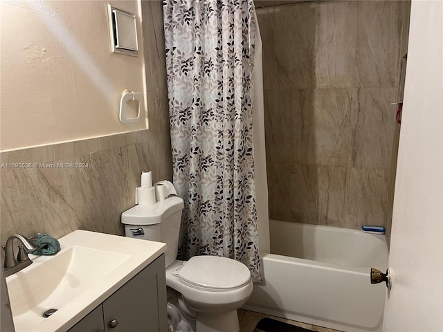 full bathroom featuring shower / bathtub combination with curtain, vanity, tile walls, and toilet