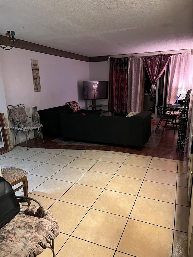 living room with tile patterned flooring and a textured ceiling