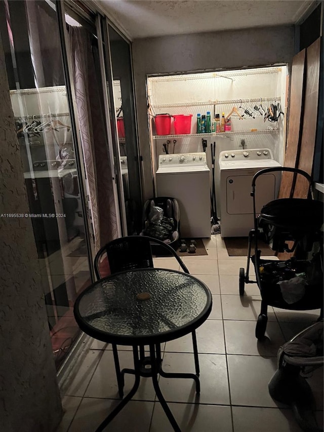 laundry room featuring light tile patterned floors and separate washer and dryer