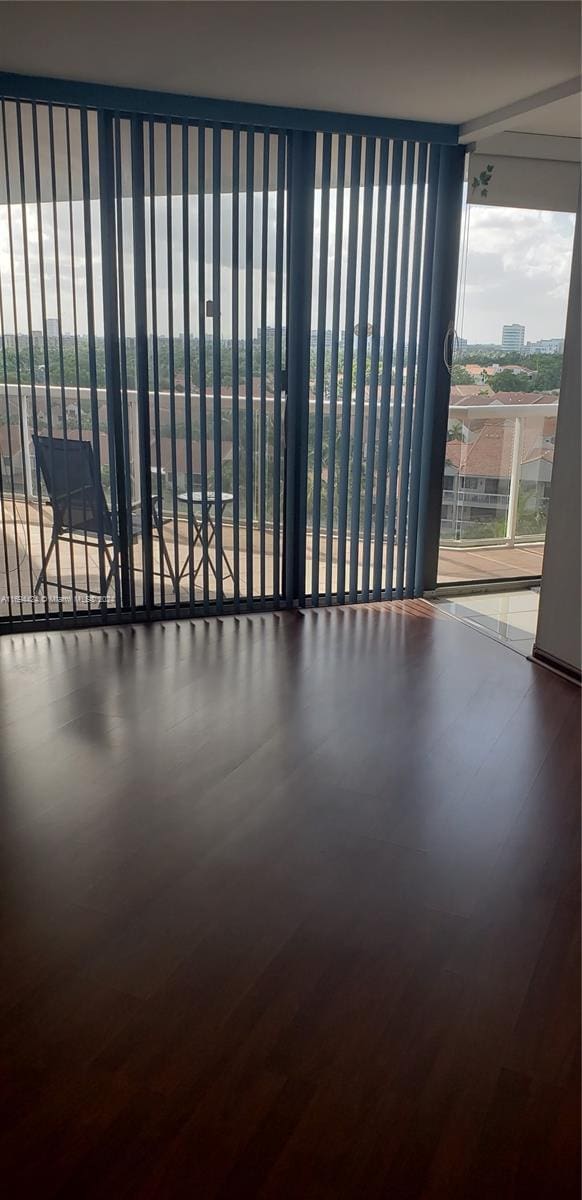 unfurnished room featuring wood-type flooring and floor to ceiling windows