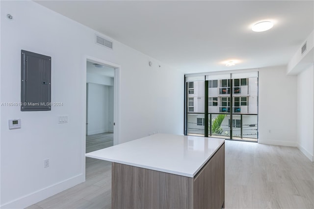 kitchen featuring a center island, light hardwood / wood-style floors, and electric panel