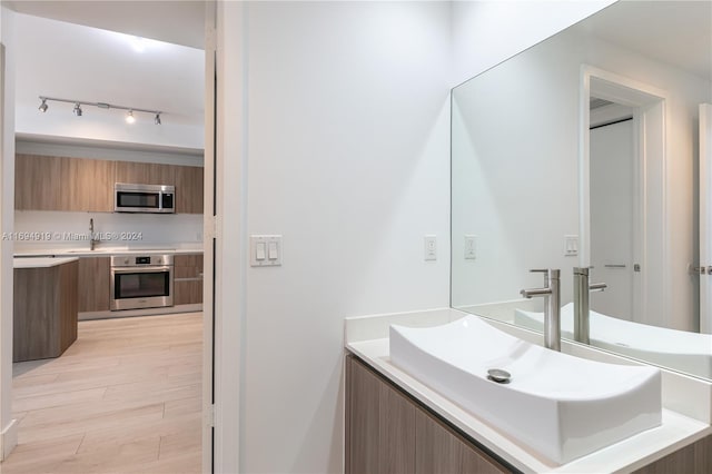 bathroom with hardwood / wood-style flooring and vanity