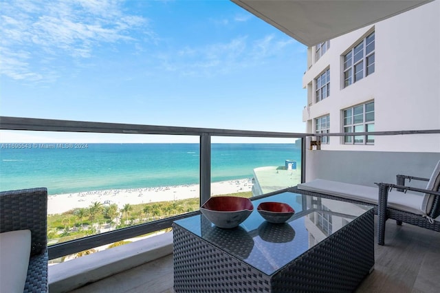 balcony with a view of the beach and a water view