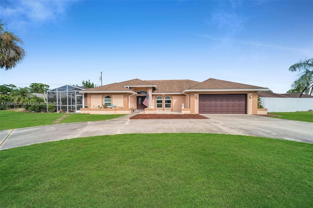 view of front of home featuring glass enclosure, a garage, and a front lawn