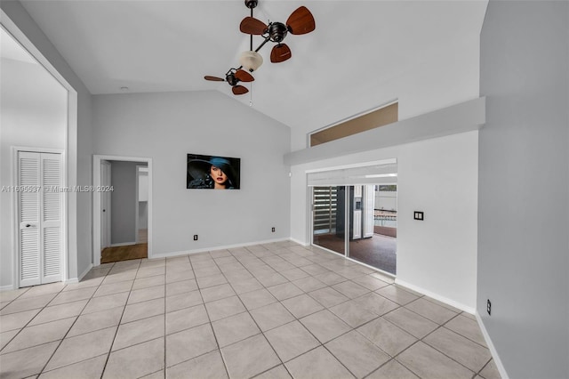 unfurnished bedroom with light tile patterned floors, high vaulted ceiling, and ceiling fan