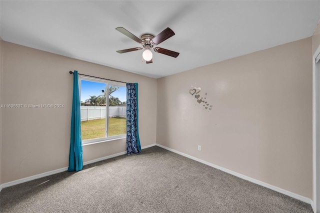 empty room with ceiling fan and carpet