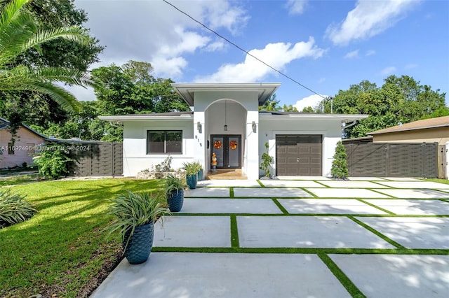 view of front of property with a front lawn and a garage