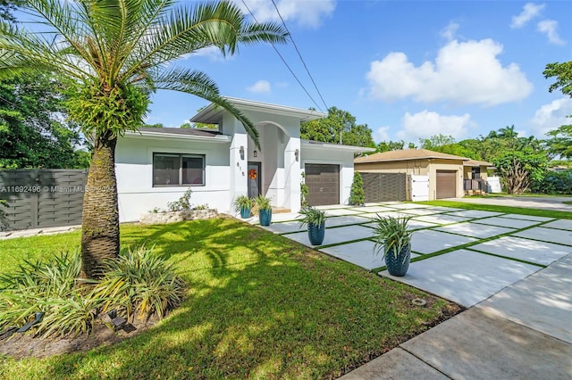 view of front of property featuring a garage and a front yard