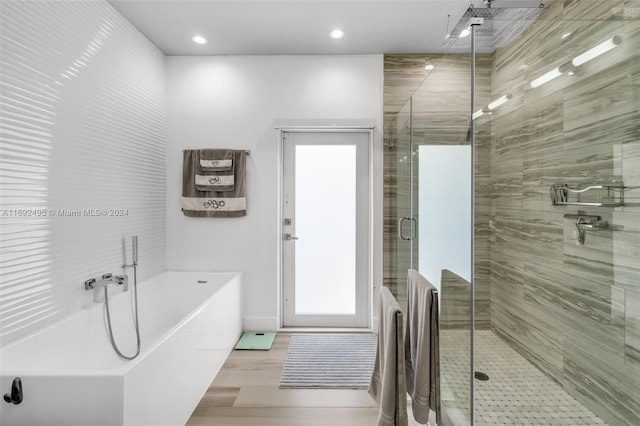 bathroom featuring independent shower and bath and wood-type flooring