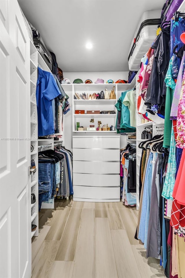 spacious closet with light hardwood / wood-style flooring