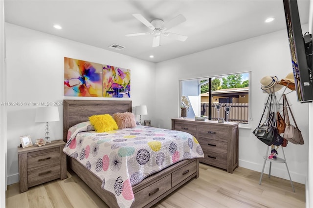 bedroom with light hardwood / wood-style flooring and ceiling fan