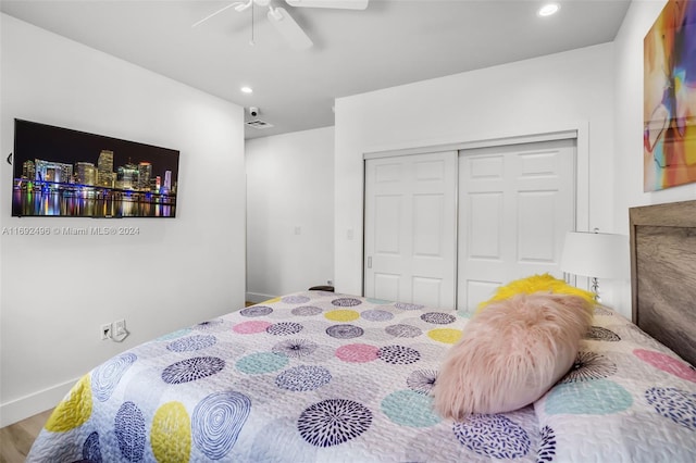 bedroom featuring hardwood / wood-style floors, a closet, and ceiling fan