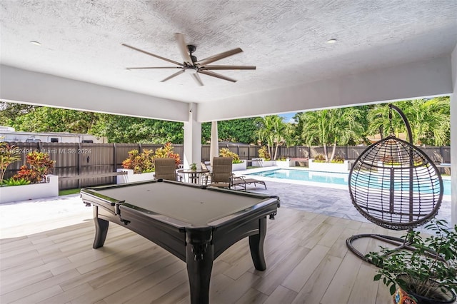 exterior space featuring pool table, a textured ceiling, and light wood-type flooring