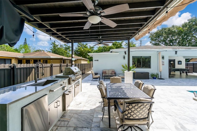 view of patio / terrace with area for grilling, ceiling fan, sink, and exterior kitchen