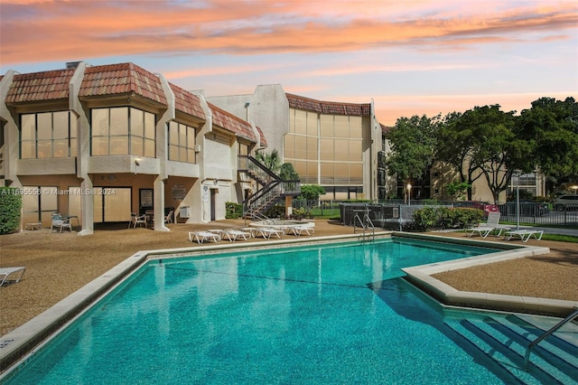 view of pool at dusk