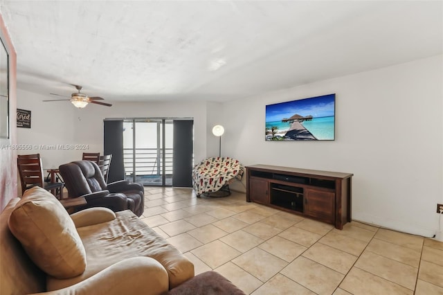 living room featuring ceiling fan and light tile patterned flooring