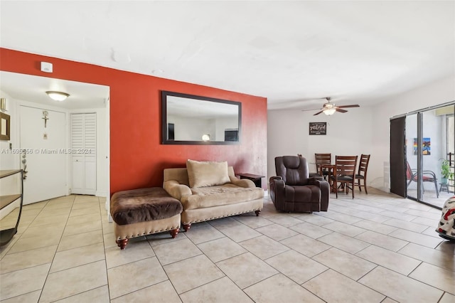 tiled living room with ceiling fan