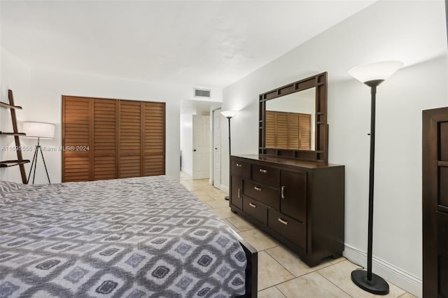 tiled bedroom with a closet