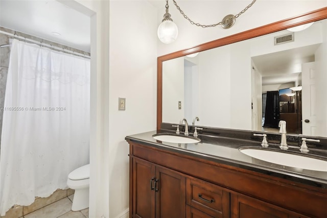 bathroom with tile patterned floors, vanity, and toilet