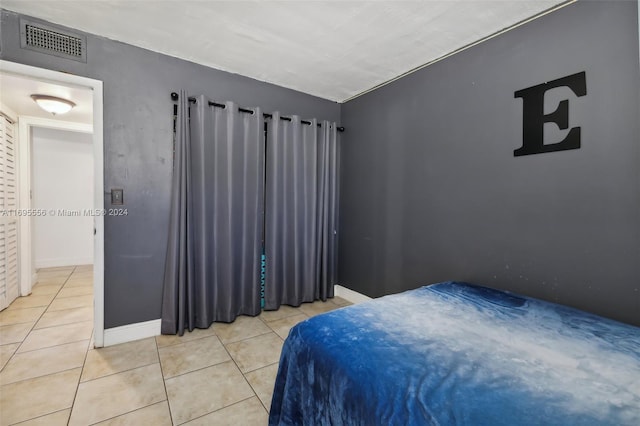 bedroom featuring light tile patterned floors