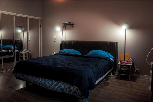 bedroom featuring dark hardwood / wood-style floors and a closet