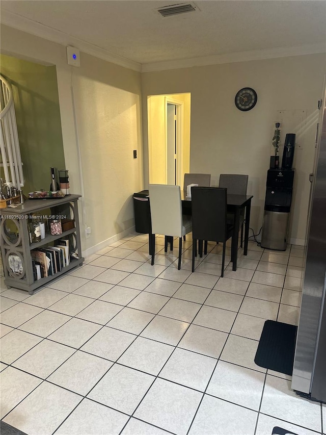 dining room with light tile patterned floors and ornamental molding