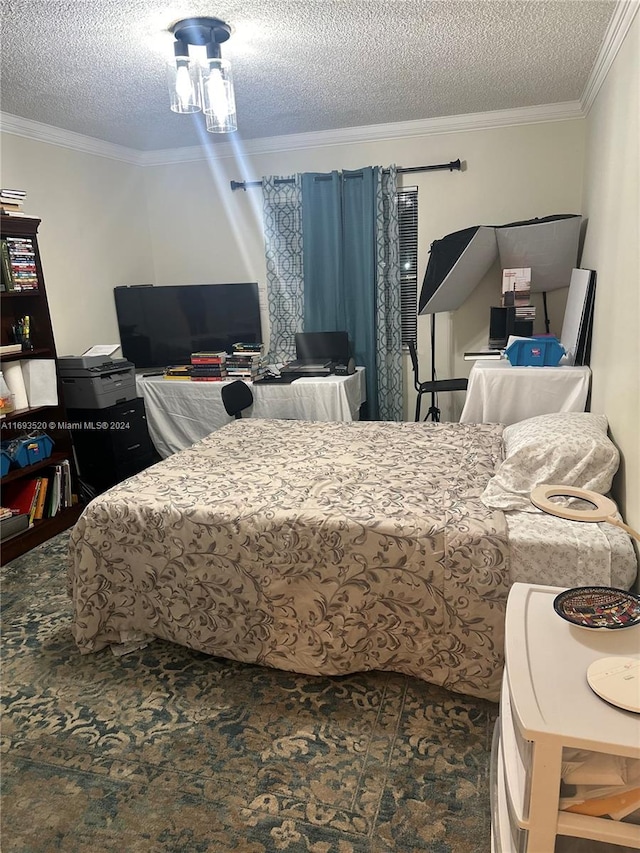 bedroom with a textured ceiling and ornamental molding