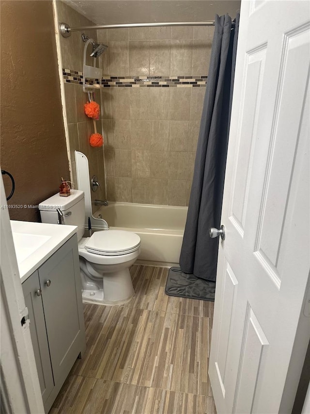 full bathroom featuring vanity, toilet, wood-type flooring, and shower / bath combo with shower curtain