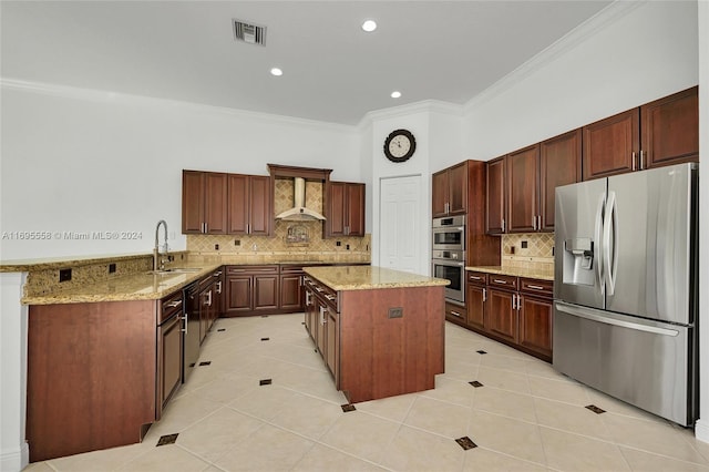 kitchen featuring kitchen peninsula, appliances with stainless steel finishes, wall chimney exhaust hood, light tile patterned floors, and a center island