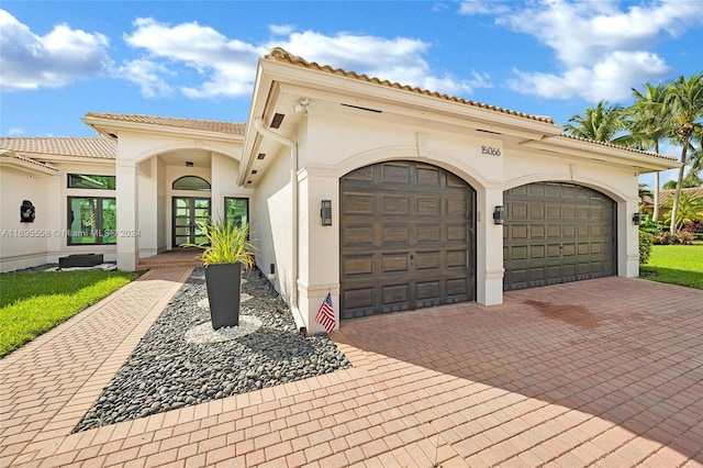 mediterranean / spanish-style house with a garage