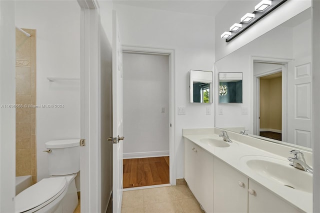 bathroom with tile patterned flooring, vanity, and toilet