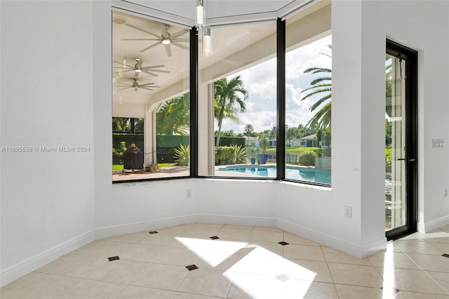 unfurnished room featuring plenty of natural light and light tile patterned flooring