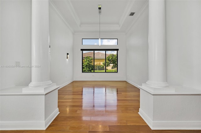 interior space with hardwood / wood-style flooring and crown molding