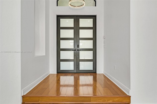 foyer entrance featuring french doors and hardwood / wood-style flooring