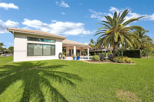 rear view of house featuring a lawn