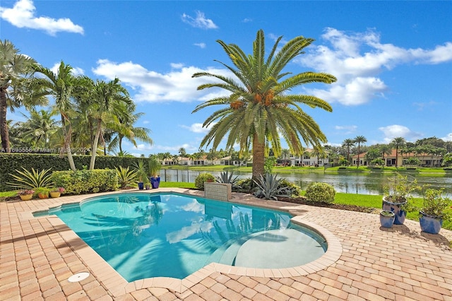 view of swimming pool featuring a water view and a patio