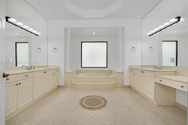 bathroom featuring decorative columns, a tub, tile patterned flooring, and vanity