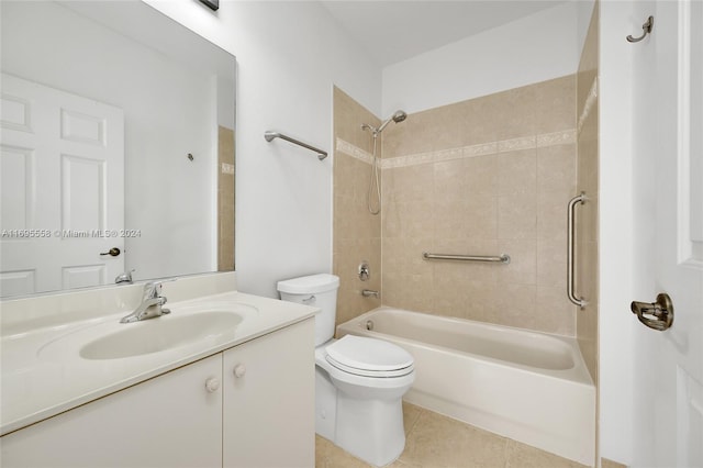 full bathroom with tile patterned flooring, tiled shower / bath combo, toilet, and vanity