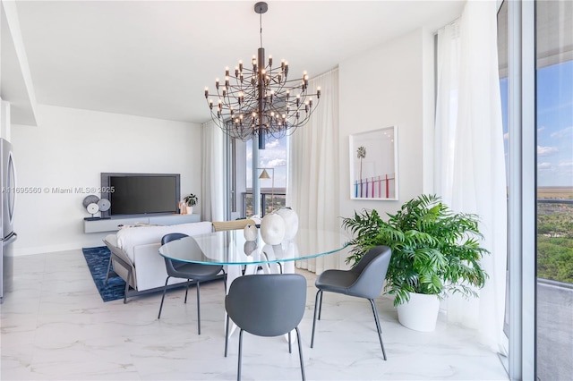 dining space with a wealth of natural light and a chandelier