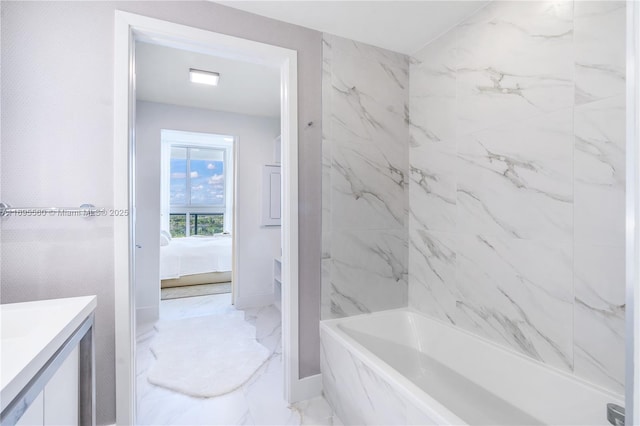 bathroom with tiled shower / bath combo and vanity