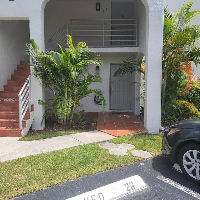 3564 Magellan Cir Unit 211-1, Aventura, FL 33180 - doorway to property with stucco siding, uncovered parking, and a balcony