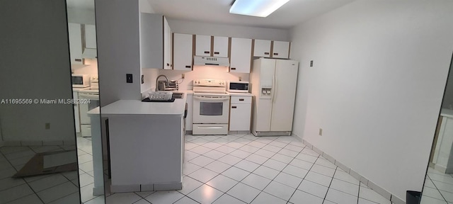 kitchen with range hood, white cabinets, white appliances, and light tile patterned floors