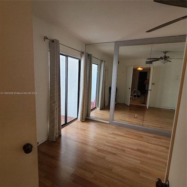 3564 Magellan Cir Unit 211-1, Aventura, FL 33180 - spare room featuring wood finished floors and ceiling fan