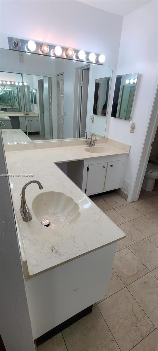 3564 Magellan Cir Unit 211-1, Aventura, FL 33180 - full bath featuring vanity, toilet, and tile patterned flooring