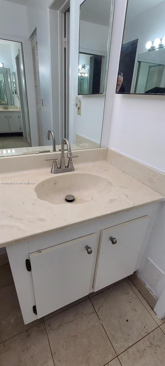 bathroom with tile patterned floors and vanity